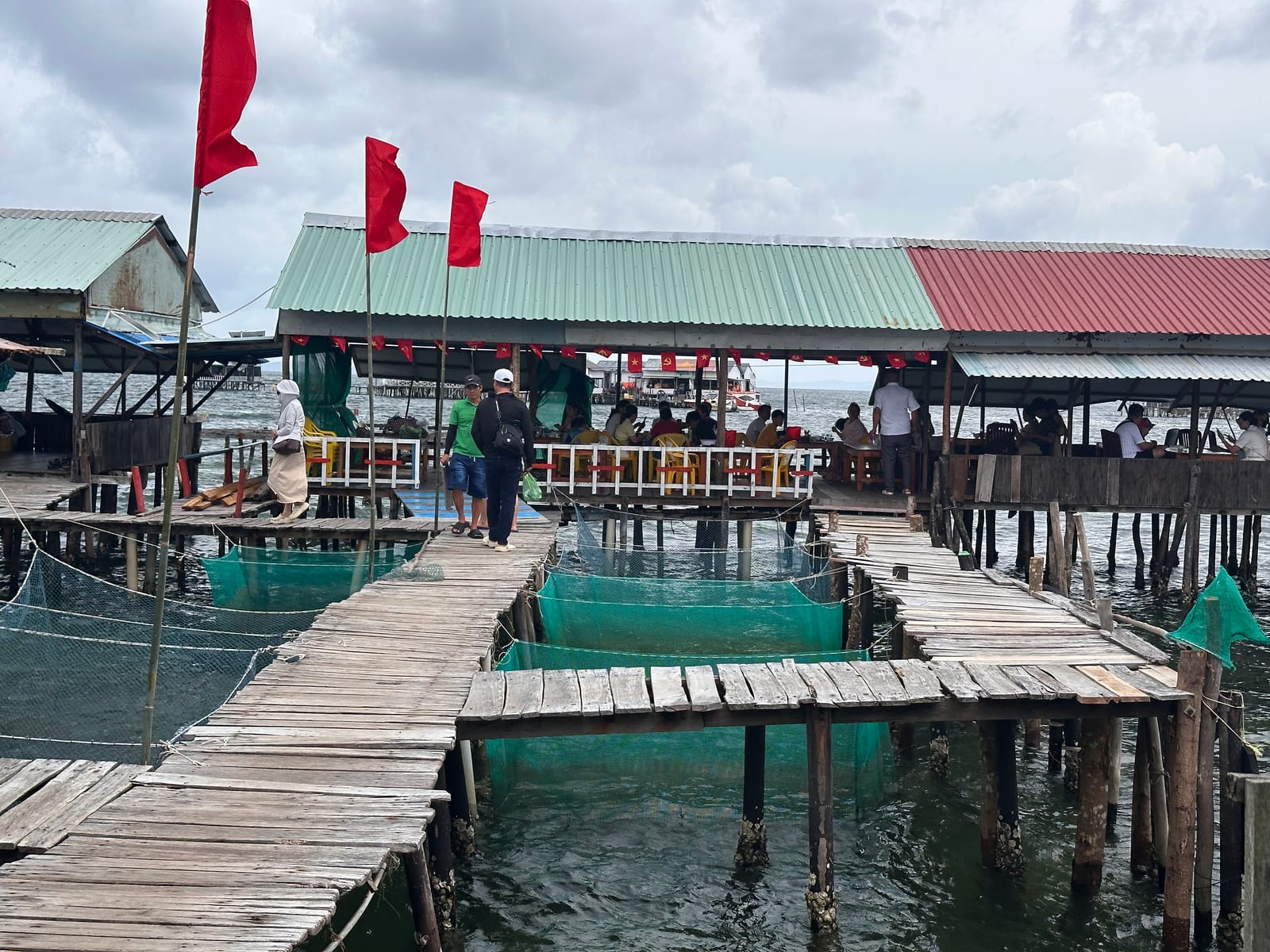 Wooden walkways and seafood pens linking the rafts at Rach Vem